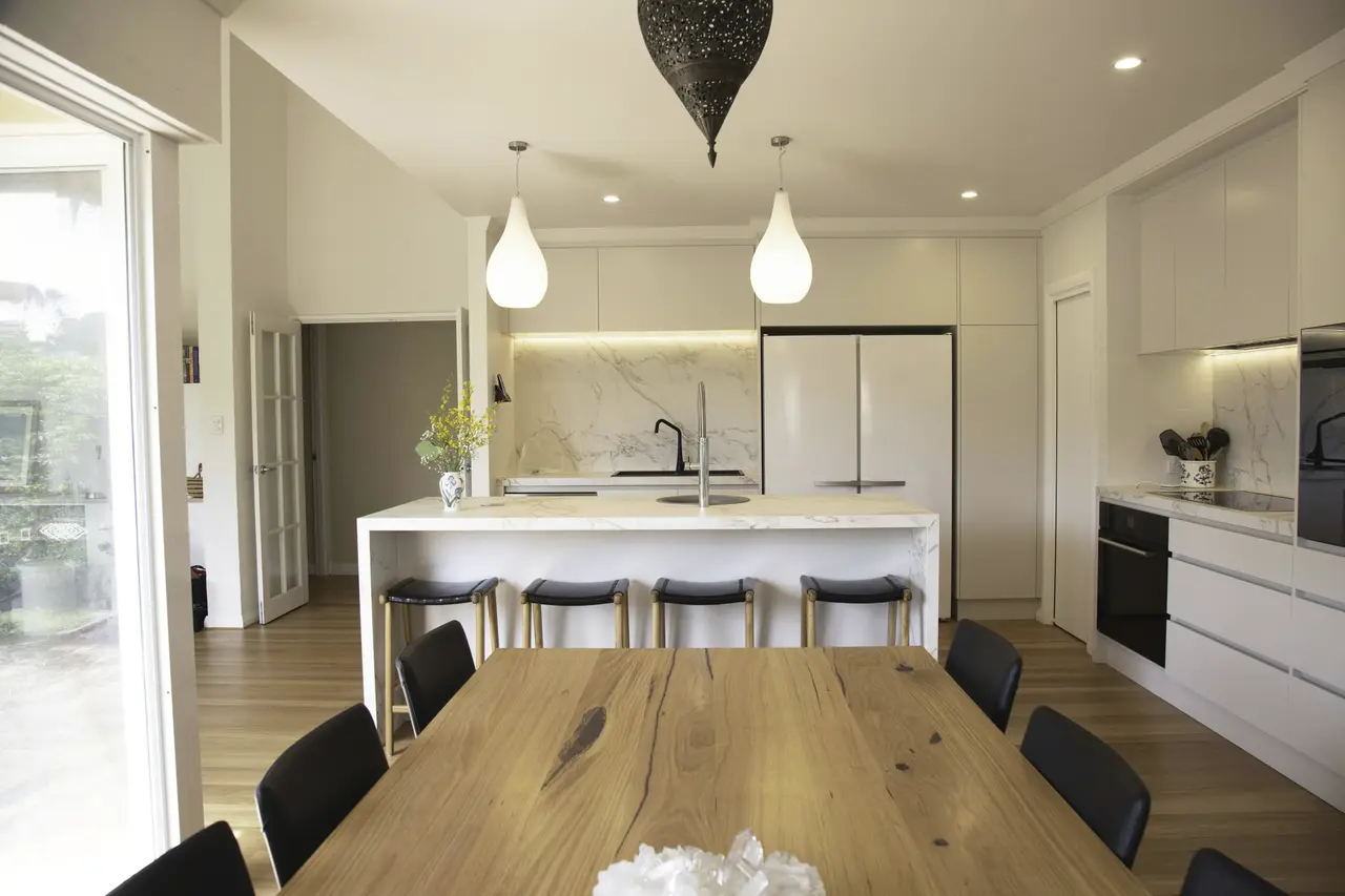 An open-plan kitchen and dining room with clear benches